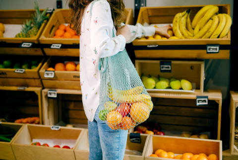 Woman grocery shopping for fruit