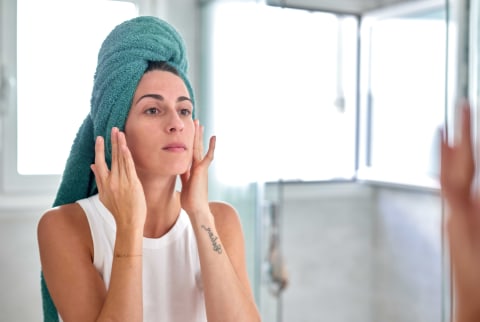 Woman putting on serum